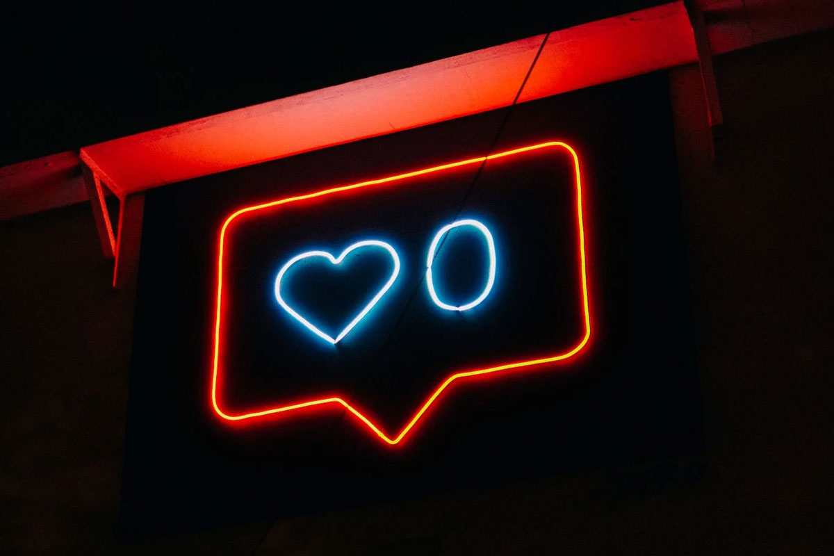 Insurance Advisors Direct helps agents with marketing with social media. Neon "like" sign in a dark room.